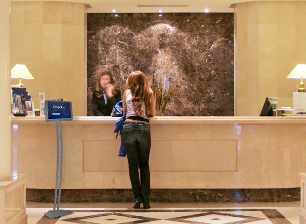 Woman at hotel lobby counter