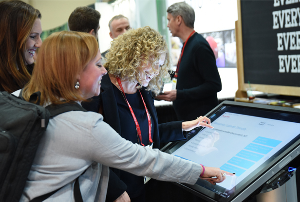 women using touchscreen kiosk