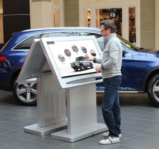 Man at auto dealer kiosk