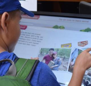 boy using touchscreen kiosk